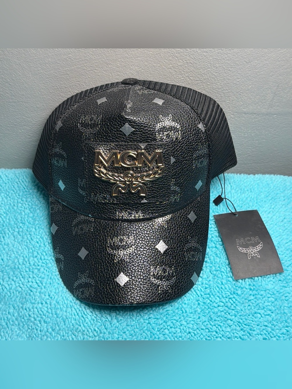 MCM Black Logo Plaque Trucker Hat with Gold Emblem